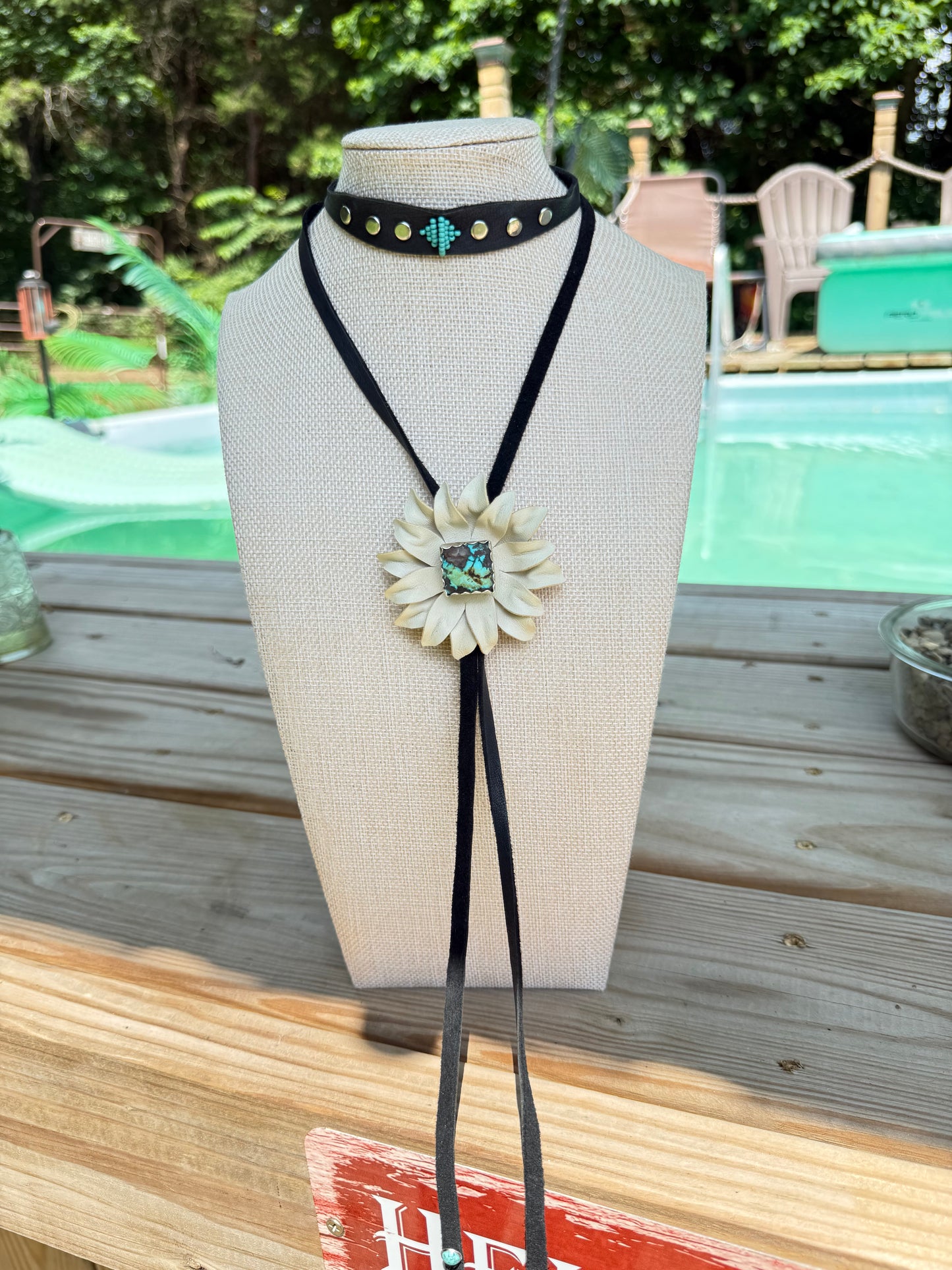 Genuine turquoise and sterling silver bolo, set with a leather flower