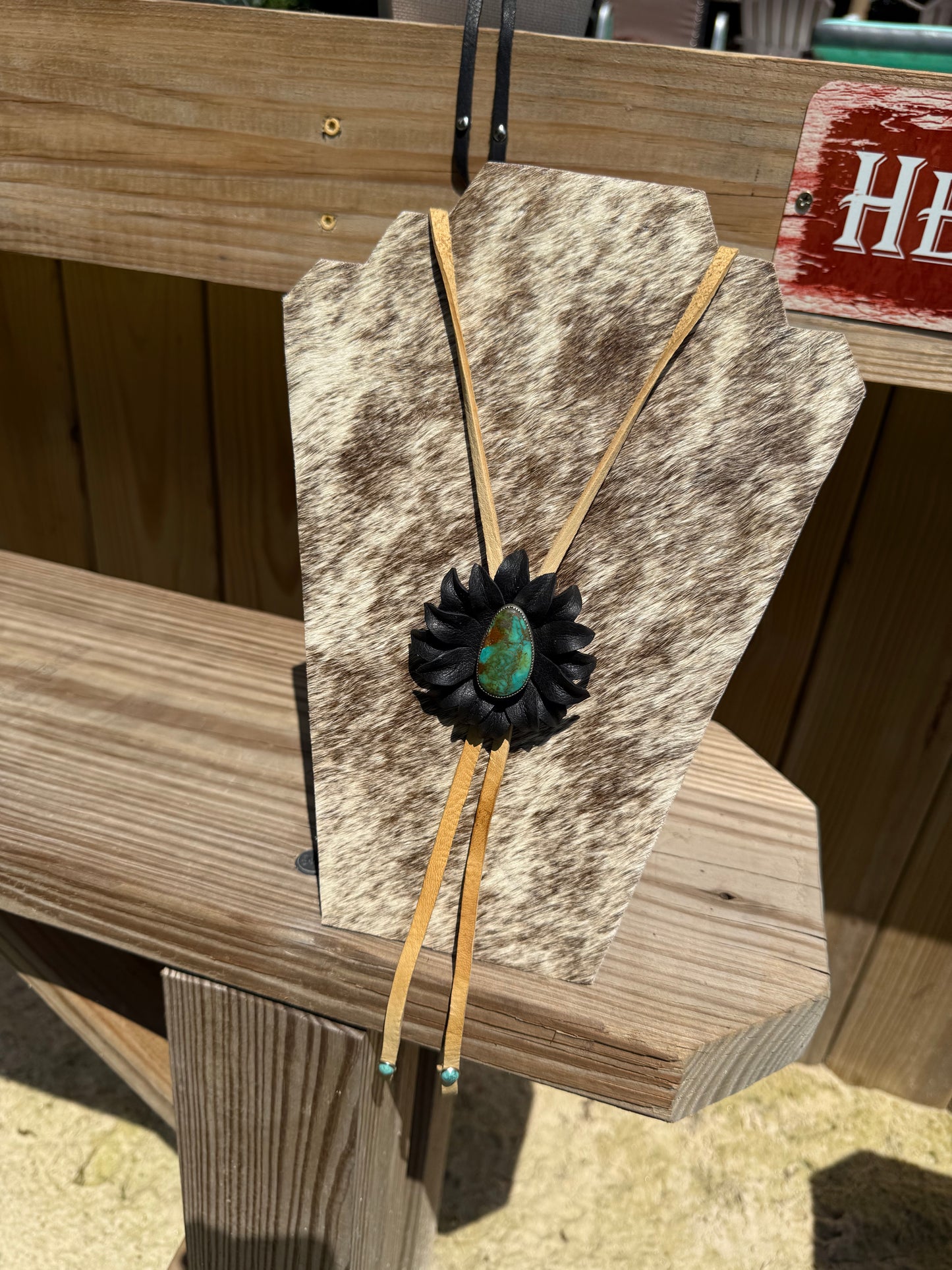 Genuine turquoise and sterling silver bolo, set with a leather flower