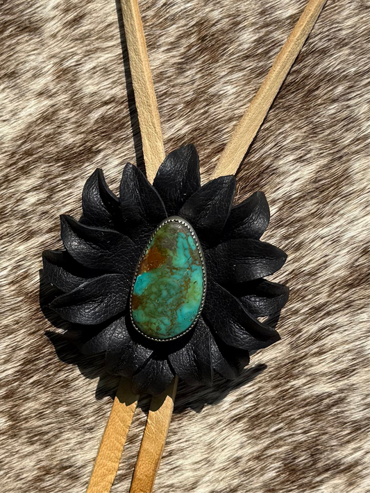 Genuine turquoise and sterling silver bolo, set with a leather flower